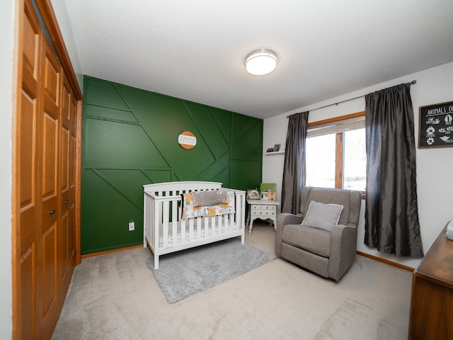 carpeted bedroom featuring a closet and a crib