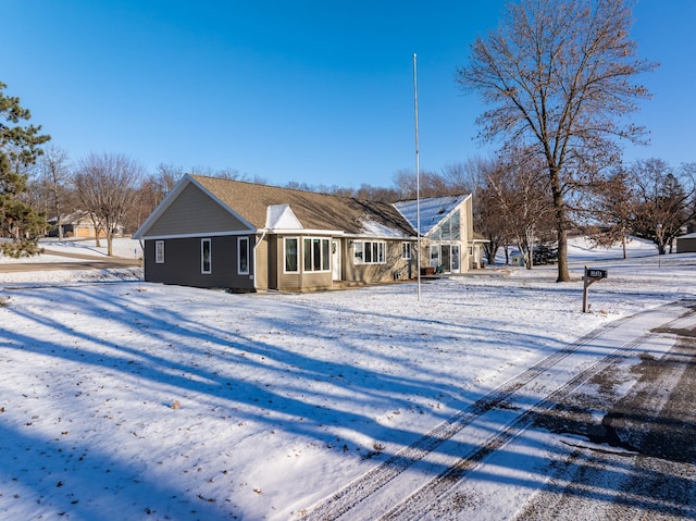 view of snow covered back of property