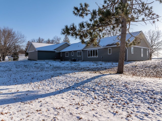 view of snow covered rear of property