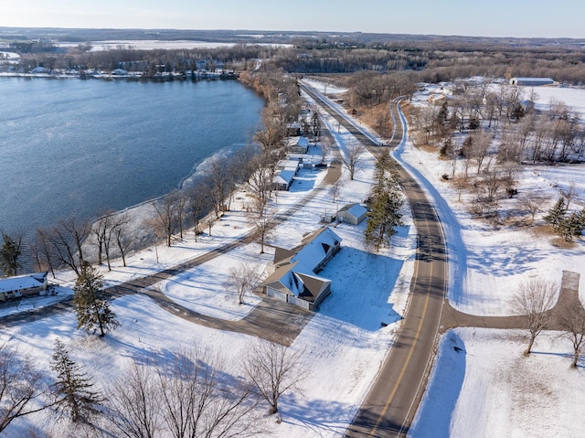 snowy aerial view featuring a water view