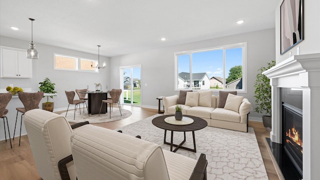 living room with a chandelier and light hardwood / wood-style floors