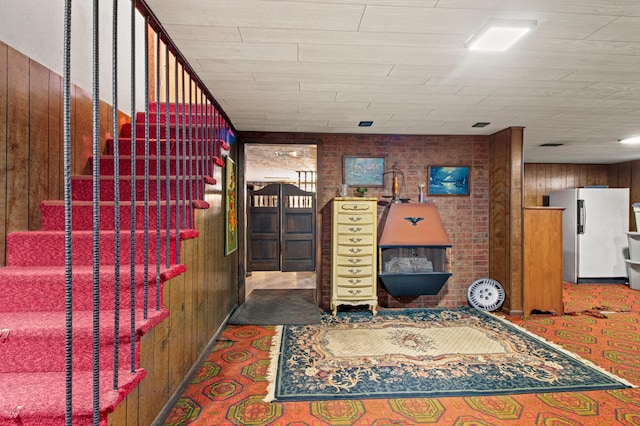 interior space with wood walls and carpet