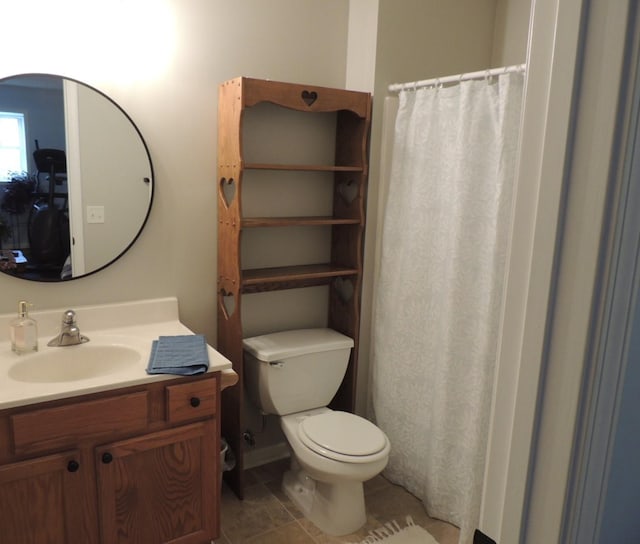 bathroom featuring tile patterned floors, vanity, and toilet