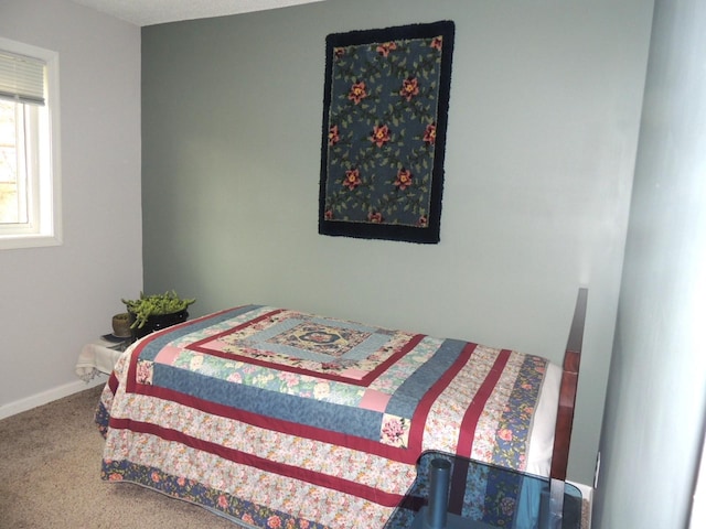 carpeted bedroom with baseboards