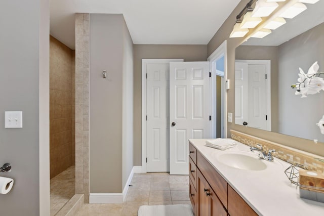 bathroom featuring vanity, tiled shower, and tile patterned floors