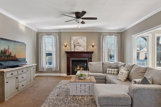 living room featuring ceiling fan, a premium fireplace, ornamental molding, and light carpet