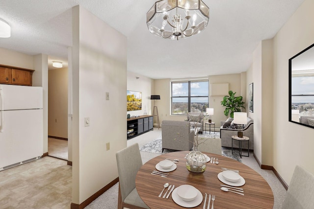 dining space with baseboards, a textured ceiling, light carpet, and a notable chandelier