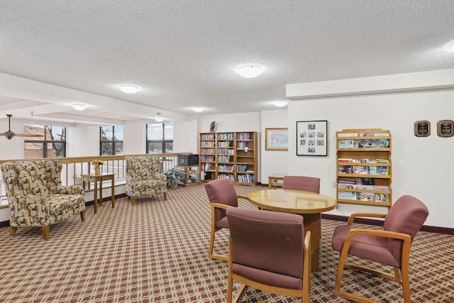 interior space featuring carpet, a textured ceiling, and baseboards