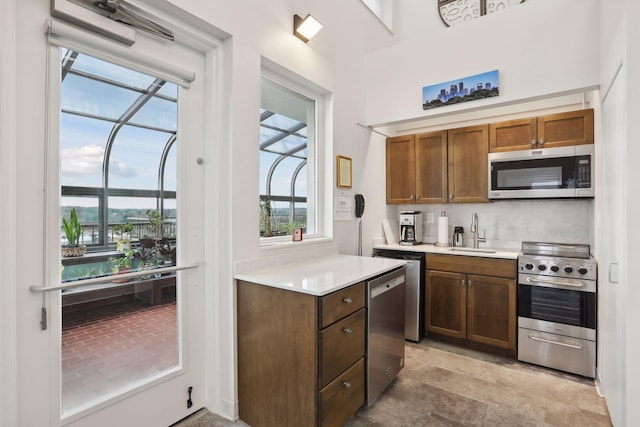 kitchen featuring appliances with stainless steel finishes, light countertops, and a sink