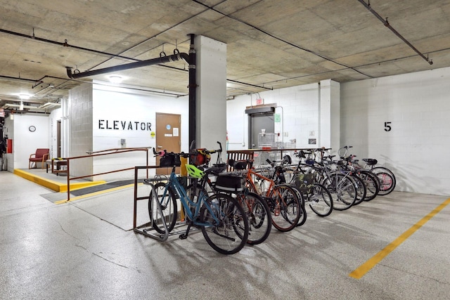 parking garage featuring bike storage and concrete block wall