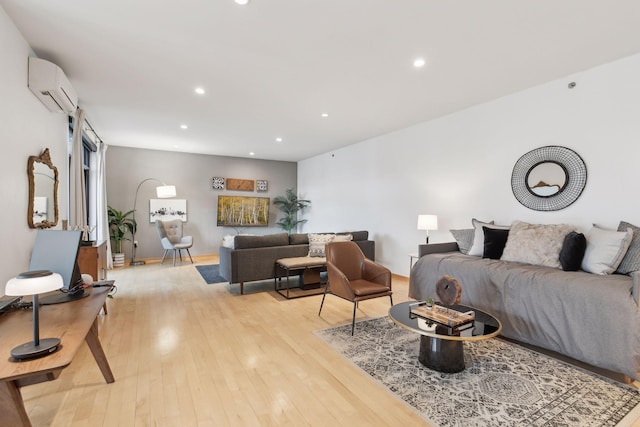 living room featuring a wall mounted AC and light hardwood / wood-style flooring