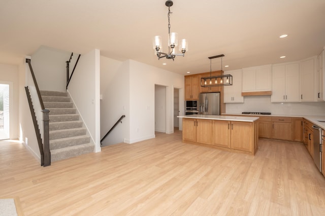 25341 Delmar Ave, New Prague, MN 56071 - kitchen featuring stainless steel fridge with ice dispenser, a center island, light wood-style flooring, a chandelier, and recessed lighting