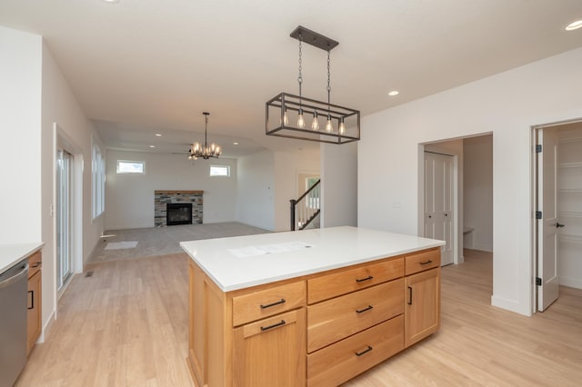 25341 Delmar Ave, New Prague, MN 56071 - kitchen featuring stainless steel dishwasher, light wood-style flooring, a fireplace, light brown cabinetry, and recessed lighting