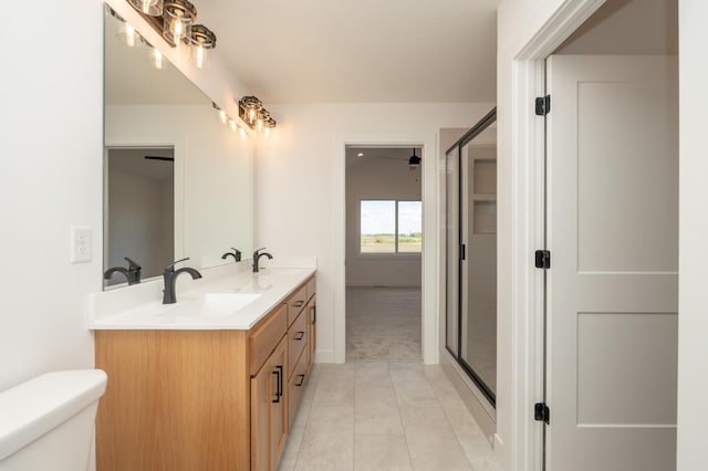 25341 Delmar Ave, New Prague, MN 56071 - bathroom featuring double vanity, tile patterned floors, toilet, and a stall shower