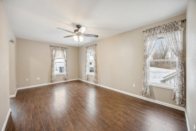 unfurnished room featuring ceiling fan and dark wood-type flooring