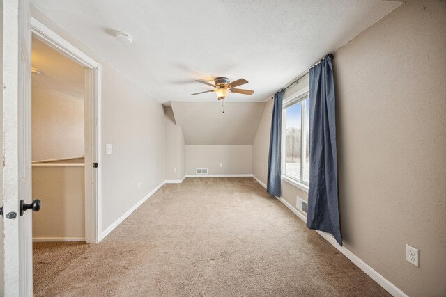 bonus room featuring light carpet, vaulted ceiling, and ceiling fan