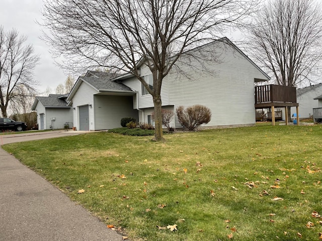 view of home's exterior featuring a garage, a wooden deck, and a lawn