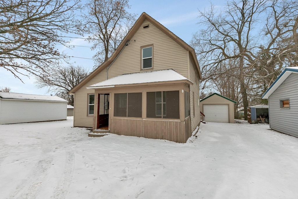 view of front of property featuring a garage and an outdoor structure