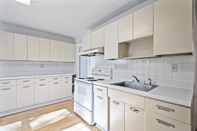 kitchen with white cabinets, sink, light hardwood / wood-style flooring, electric range, and decorative backsplash