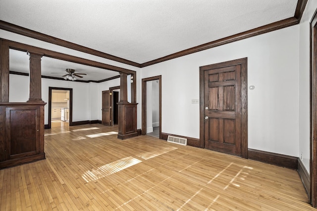 entryway with ornate columns, ceiling fan, hardwood / wood-style floors, and a textured ceiling