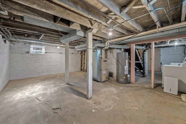 basement featuring heating unit, washer / clothes dryer, and water heater