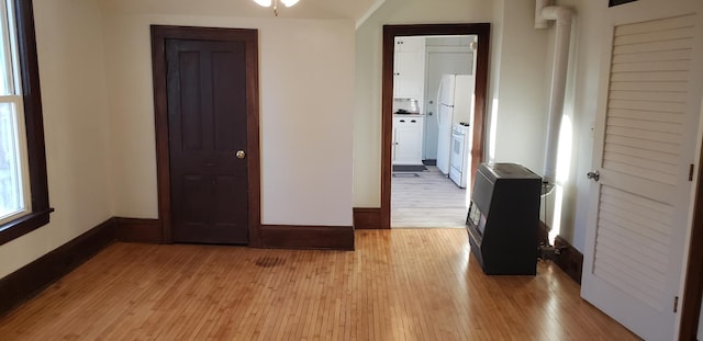 interior space with white refrigerator and light hardwood / wood-style floors