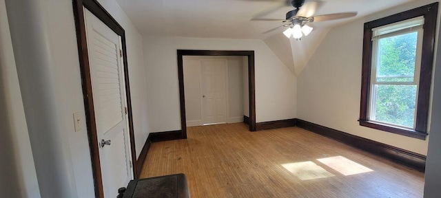 unfurnished bedroom with vaulted ceiling, light hardwood / wood-style flooring, and ceiling fan