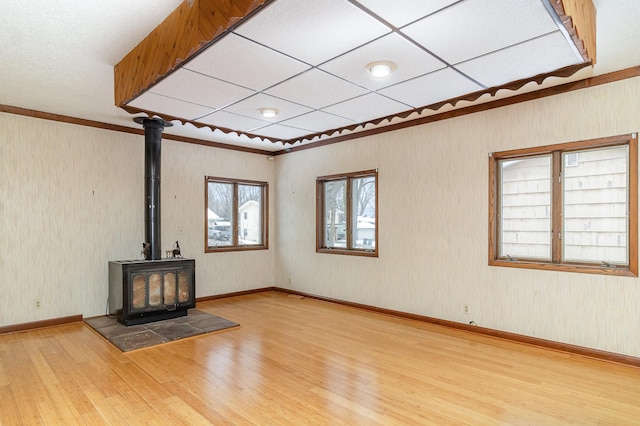 unfurnished living room featuring light wood-type flooring and a wood stove