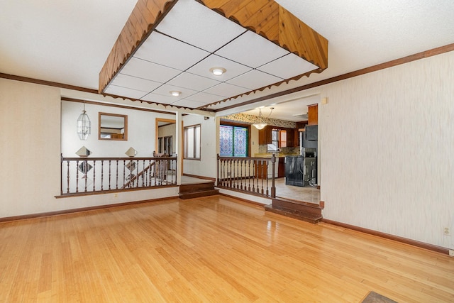 spare room featuring crown molding and hardwood / wood-style floors