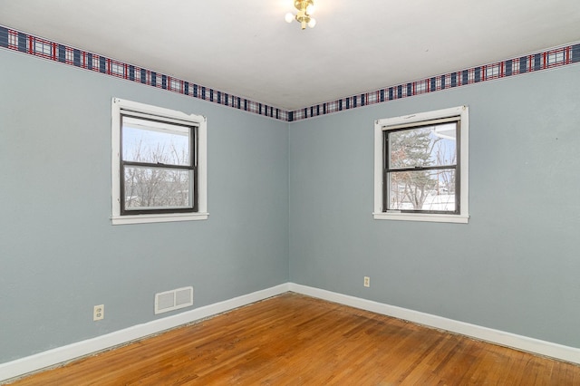 spare room featuring hardwood / wood-style flooring