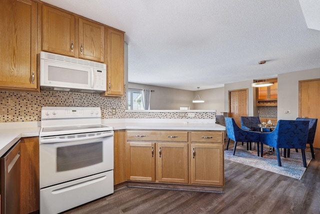 kitchen featuring backsplash, white appliances, and dark wood-type flooring