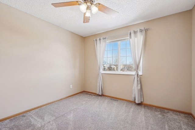 unfurnished room with carpet flooring, a textured ceiling, and ceiling fan