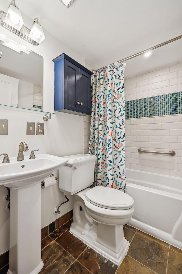 full bathroom featuring shower / bath combination with curtain, toilet, and sink