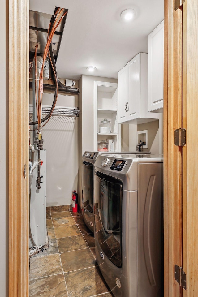 laundry area featuring cabinets and washing machine and clothes dryer