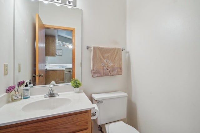 bathroom featuring toilet and vanity