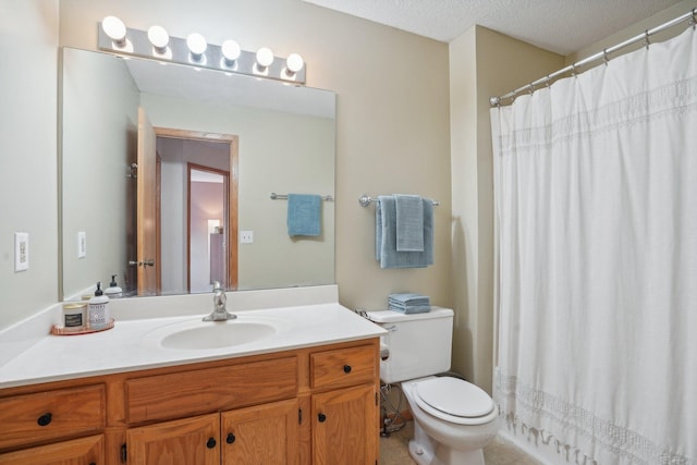 full bath featuring curtained shower, vanity, toilet, and a textured ceiling