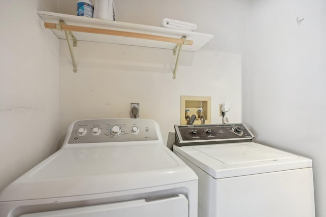 clothes washing area featuring laundry area and washer and clothes dryer