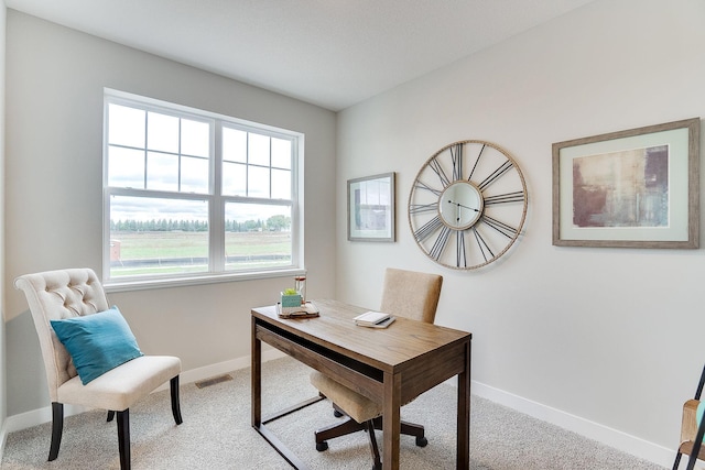 office space featuring carpet floors, visible vents, and baseboards