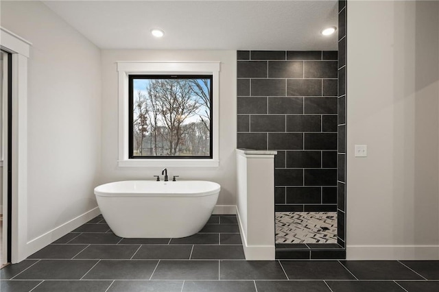 bathroom featuring tile patterned flooring and shower with separate bathtub