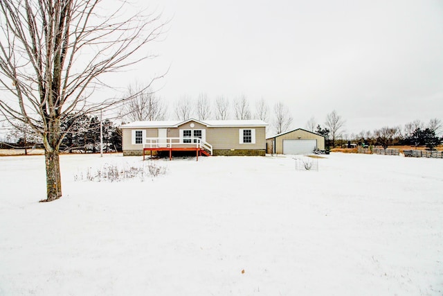 view of front of house with a wooden deck, an outdoor structure, and a garage