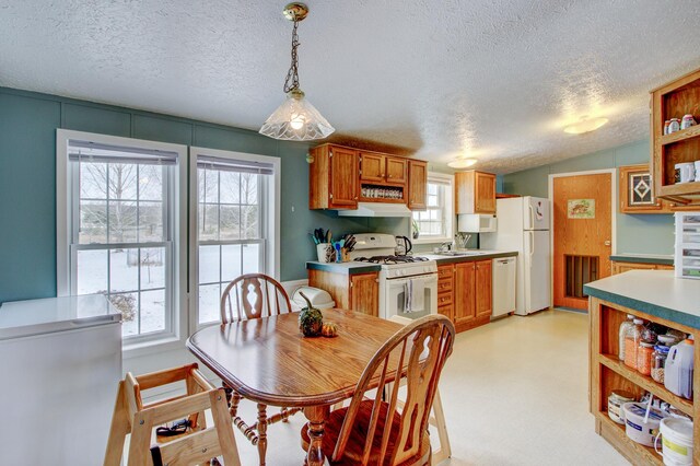 15331 129th Ave, Wadena, MN 56482 - kitchen with white appliances, open shelves, a textured ceiling, under cabinet range hood, and healthy amount of natural light