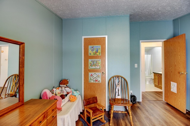 15331 129th Ave, Wadena, MN 56482 - bedroom with wood finished floors and a textured ceiling