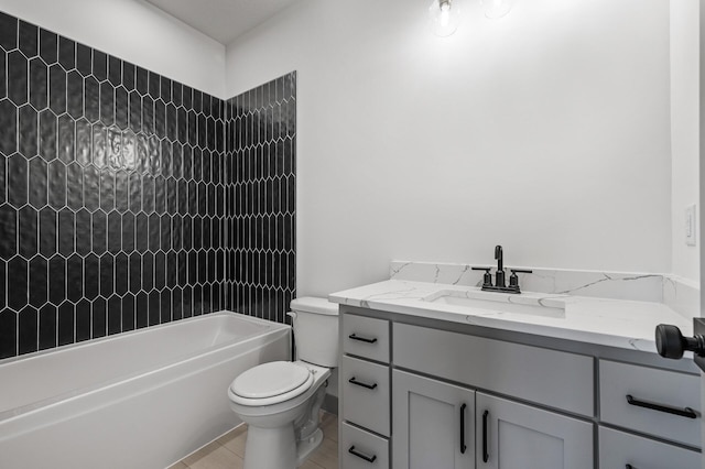 full bathroom with tile patterned flooring, vanity, tiled shower / bath combo, and toilet