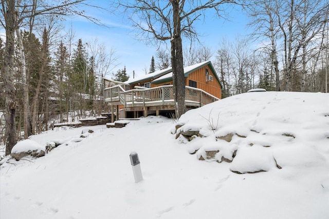 snow covered property with a wooden deck