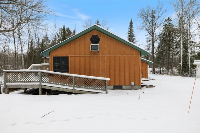 view of snow covered back of property