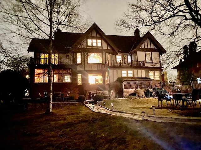 rear view of property featuring a balcony