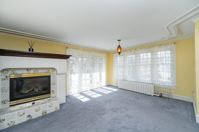 unfurnished living room featuring carpet flooring, ornamental molding, radiator, and a tile fireplace