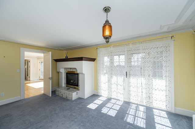 unfurnished living room featuring baseboards, carpet, and a brick fireplace