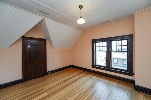 bonus room with visible vents, baseboards, lofted ceiling, and light wood finished floors