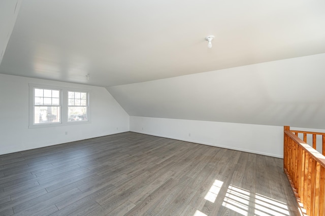 additional living space with vaulted ceiling and wood finished floors